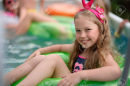 74893273-portrait-of-little-girl-in-tropical-style-in-a-swimming-pool